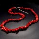 A set of beads and a bracelet on a fishing line with a lock made of natural stone Coral red