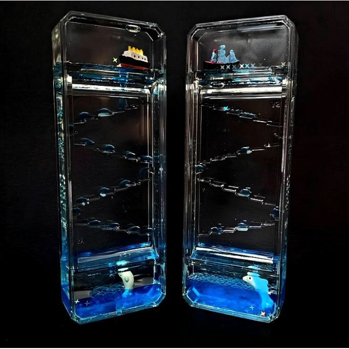 This stress-relieving hourglass features a colorful glitter gel inside, a floating boat, and a dolphin. Dimensions: 16 cm high, 5.5 cm wide.