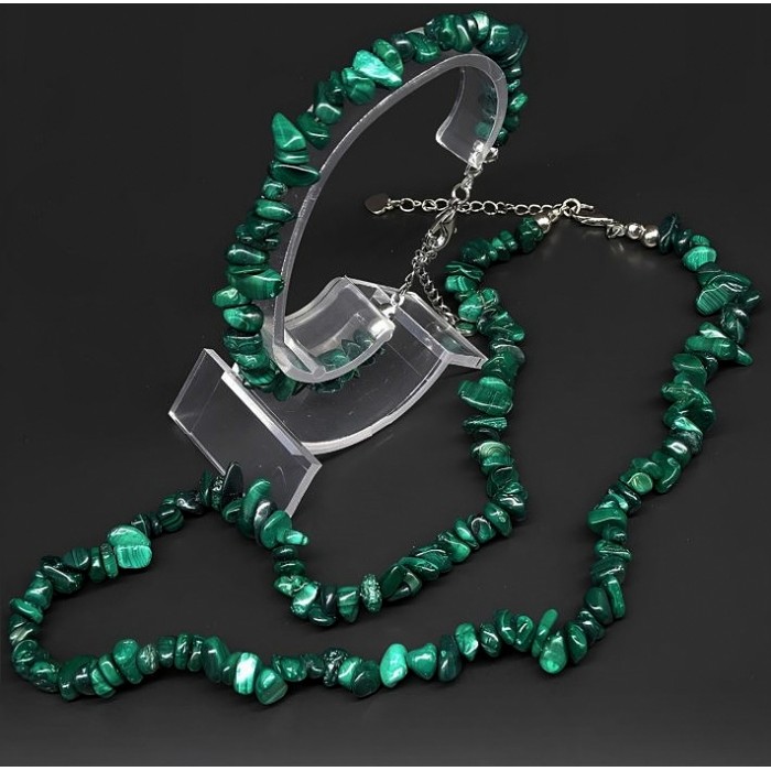 A set of beads and a bracelet on a fishing line with a lock made of natural stone Malachite