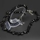 A set of beads and a bracelet on a fishing line with a lock made of natural stone black agate