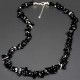 A set of beads and a bracelet on a fishing line with a lock made of natural stone black agate