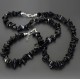 A set of beads and a bracelet on a fishing line with a lock made of natural stone black agate