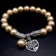 Bracelet with a pendant imitating natural Mallorca pearls, beige color