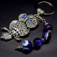 Keychain amulet of Fatima's eyes in the form of an owl with a pendant made of natural stones