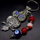 Keychain amulet of Fatima's eyes in the form of an owl with a pendant made of natural stones