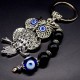 Keychain amulet of Fatima's eyes in the form of an owl with a pendant made of natural stones