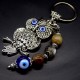 Keychain amulet of Fatima's eyes in the form of an owl with a pendant made of natural stones