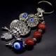 Keychain amulet of Fatima's eyes in the form of an owl with a pendant made of natural stones