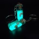 Souvenir keychain glass bottle inside colored granules luminous accumulator and natural shell