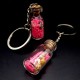 Souvenir keychain glass bottle inside colored granules luminous accumulator and natural shell