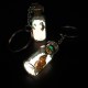 Souvenir keychain glass bottle inside colored granules luminous accumulator and natural shell