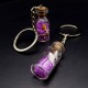 Souvenir keychain glass bottle inside colored granules luminous accumulator and natural shell