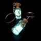 Souvenir keychain glass bottle inside colored granules luminous accumulator and natural shell