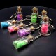 Souvenir keychain glass bottle inside colored granules luminous accumulator and natural shell