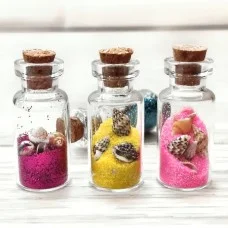 Magnet bottle with sand in a package of 12 pieces and different colors of sand.