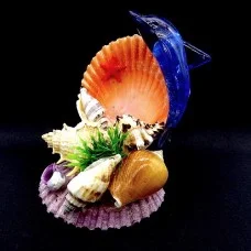 Seashell souvenir blue dolphin on a large scallop