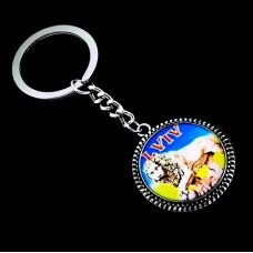 Keychain Lions from metal in the form of a circle inside a glass lens with an image