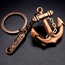 Metal keychain in the shape of a men's personalized anchor. Copper color, size: length-4.1cm, width-3.7cm
