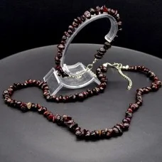 A set of beads and a bracelet on a fishing line with a lock made of natural stone Garnet