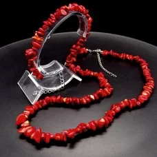 A set of beads and a bracelet on a fishing line with a lock made of natural stone Coral red