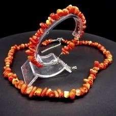 A set of beads and a bracelet on a fishing line with a lock made of natural stone Coral orange