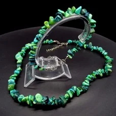 A set of beads and a bracelet on a fishing line with a lock made of natural stone Malachite