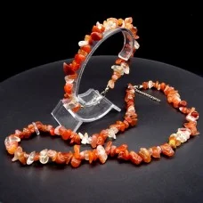 A set of beads and a bracelet on a fishing line with a lock made of natural stone Carnelian