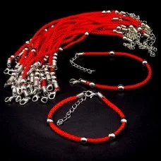 Red thread bracelet with a clasp amulet against the evil eye